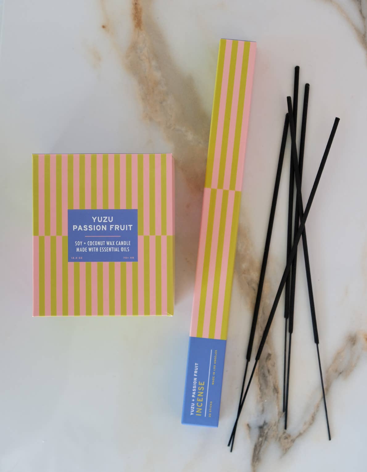 Yuzu + Passion Fruit incense sticks styled on a surface