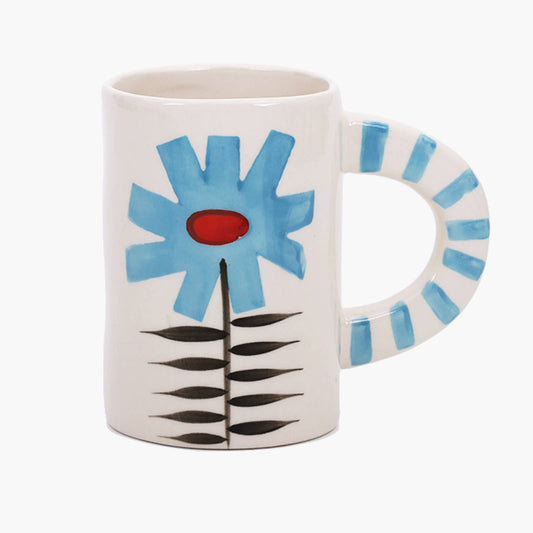 Hand-painted cream stoneware mug with a single large blue flower and a blue-and-white striped handle.