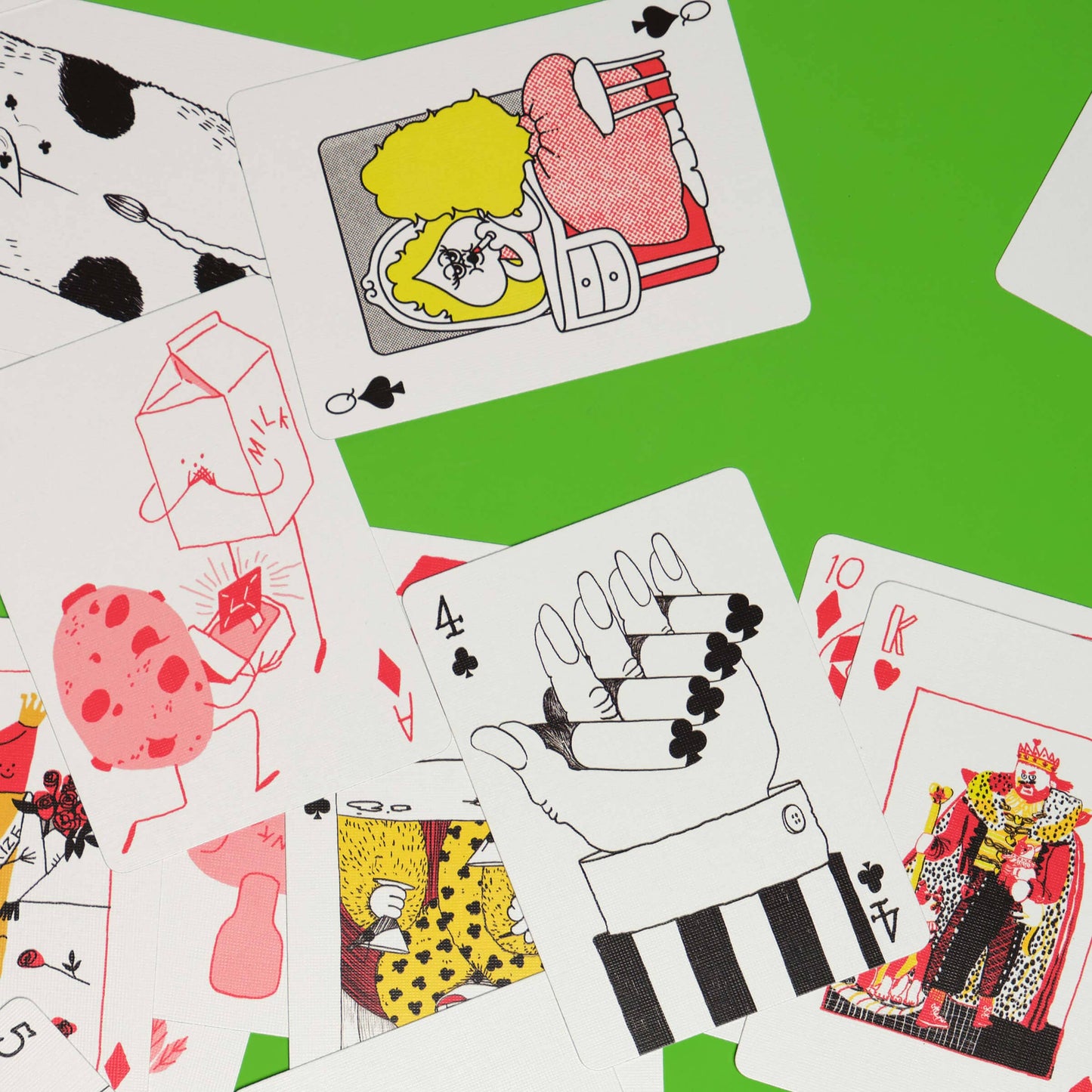 Playing cards with unique designs on a green background