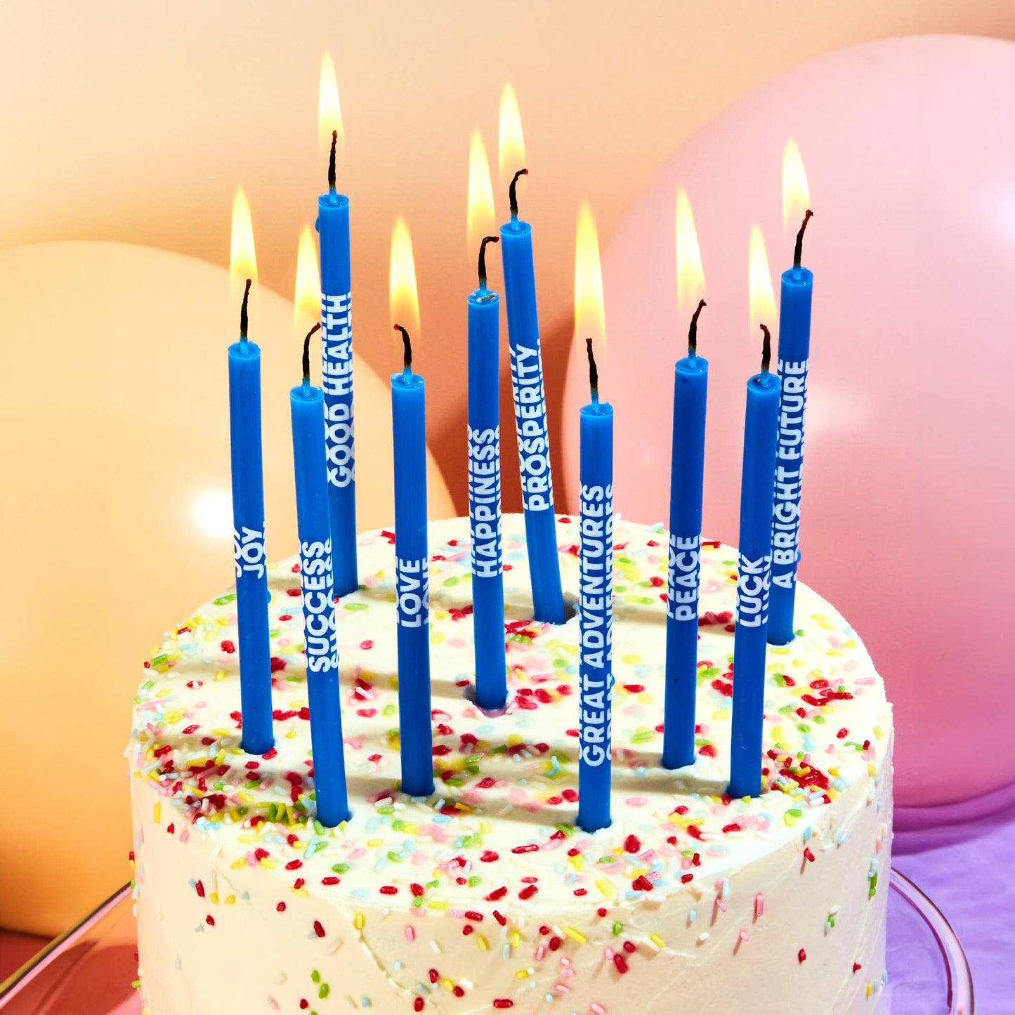 Tall 5-inch birthday candles printed with wishes like Joy, Luck, and Love