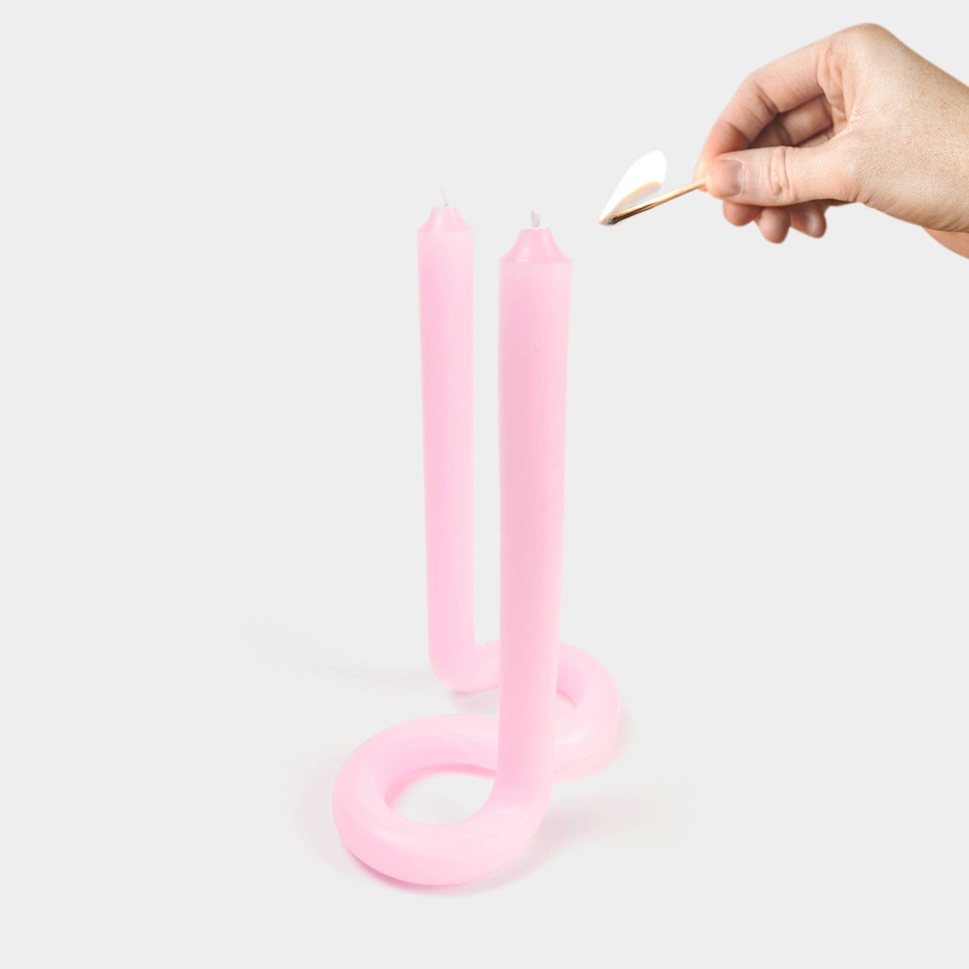 Light pink Twist candle showing its bent, twisted sculptural shape
