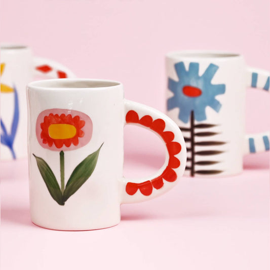 Mugs with floral designs on a pink background