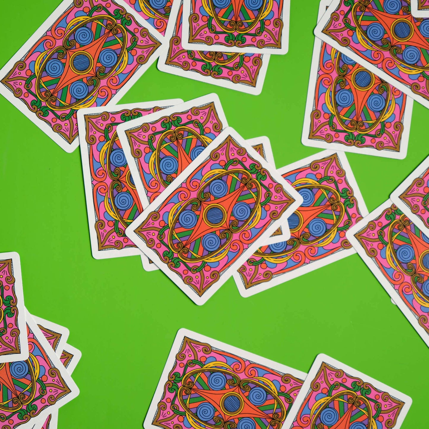 Colorful deck of cards with intricate designs on a green background