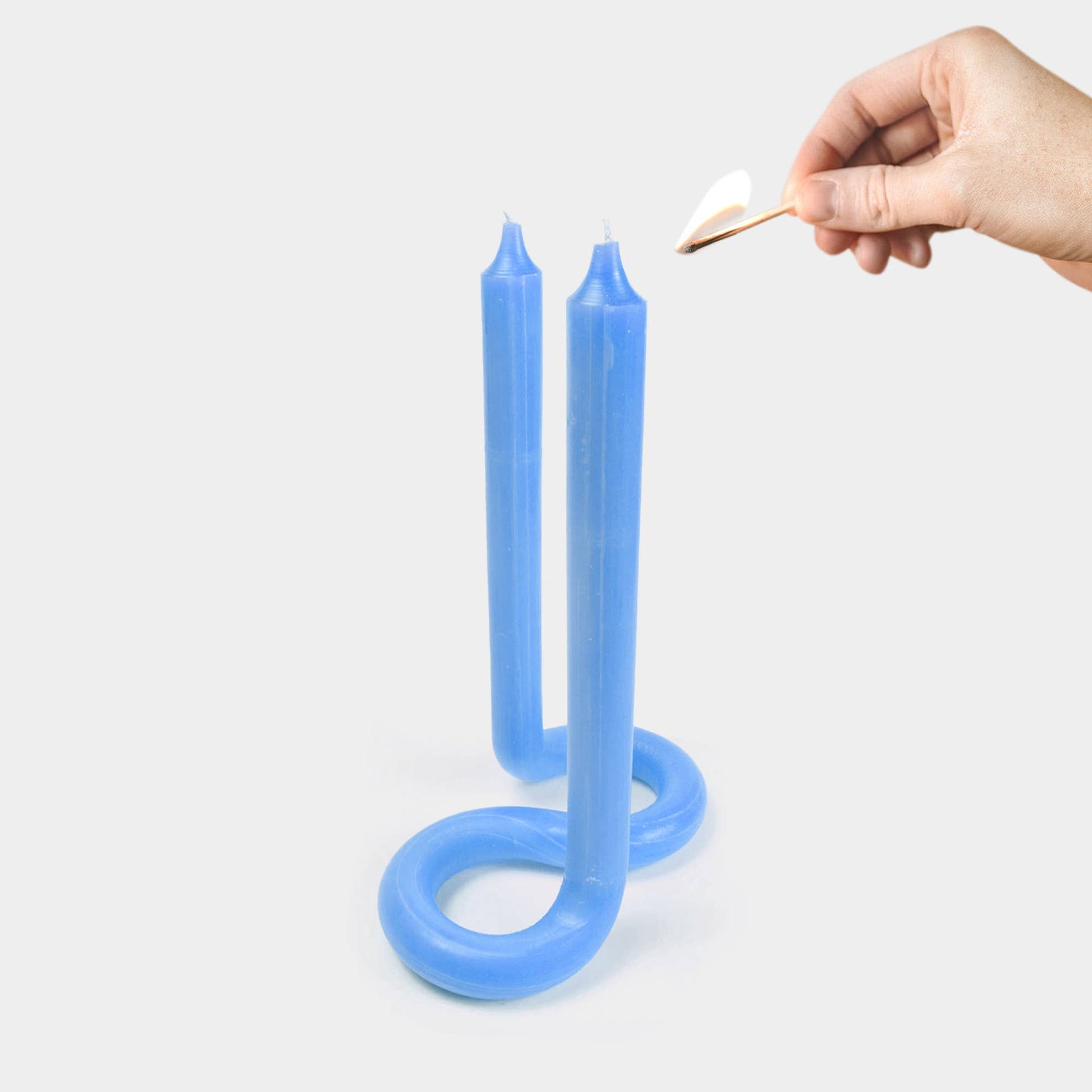 Light blue Twist candle showing its bent, twisted sculptural shape
