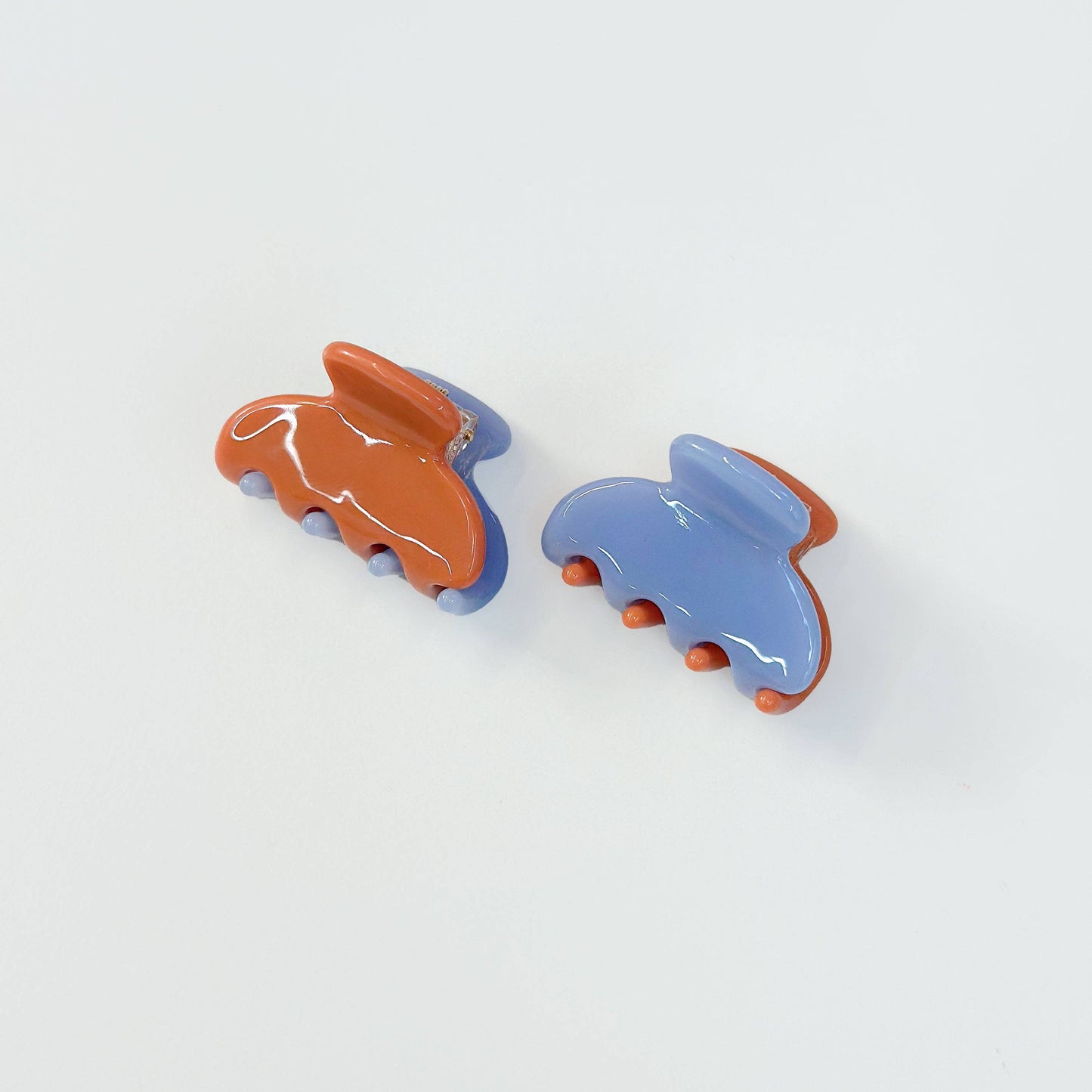 Set of two periwinkle and burnt orange jelly hair claw clips.