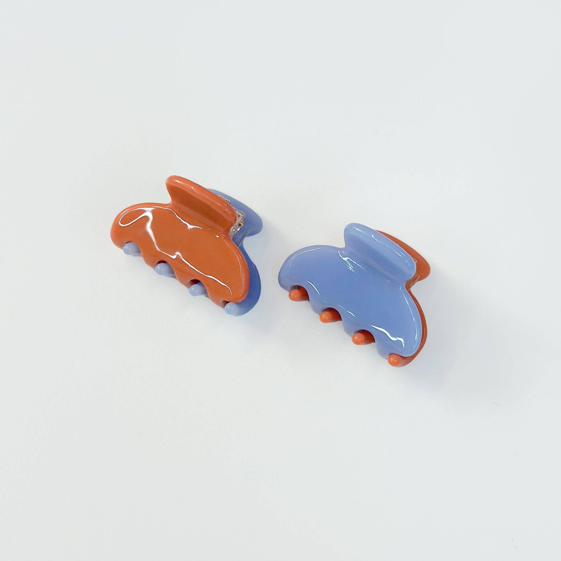 Set of two periwinkle and burnt orange jelly hair claw clips.