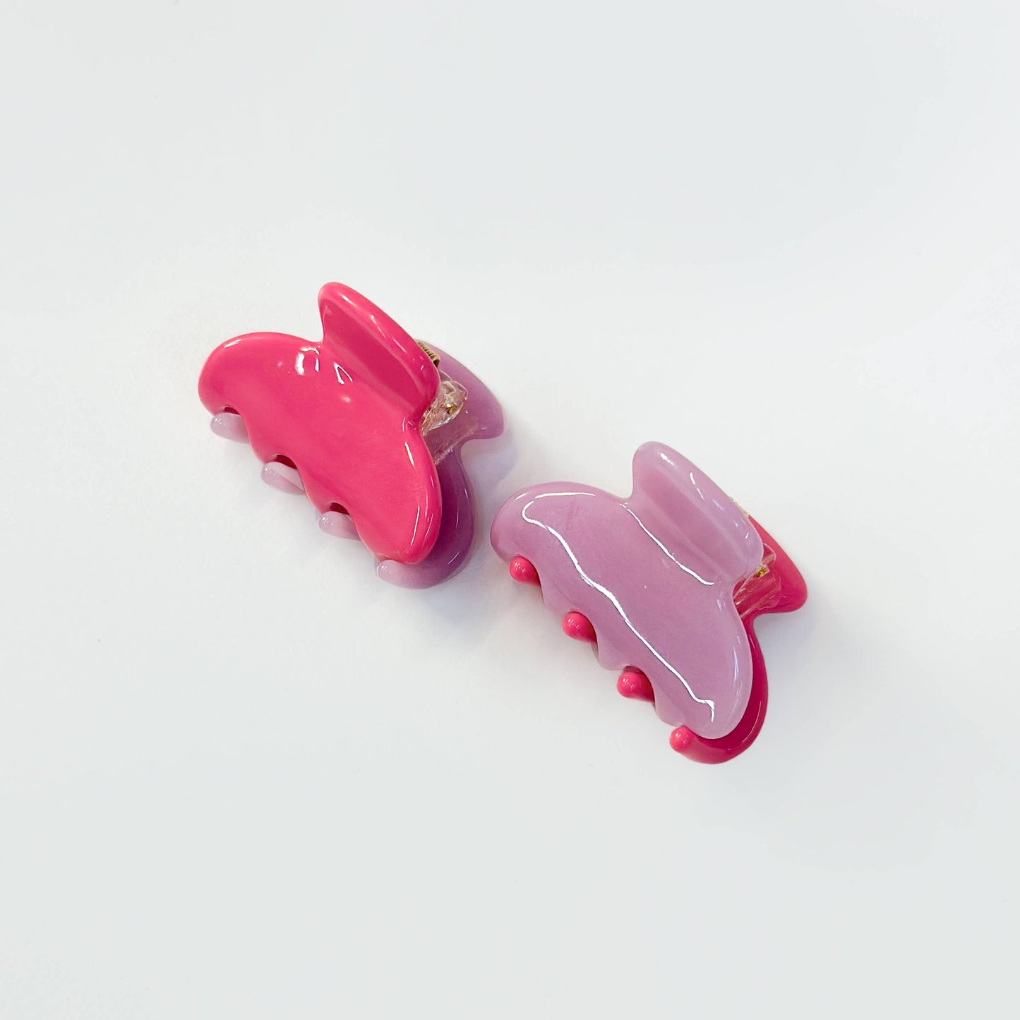 Set of two magenta and lilac translucent jelly hair claw clips.
