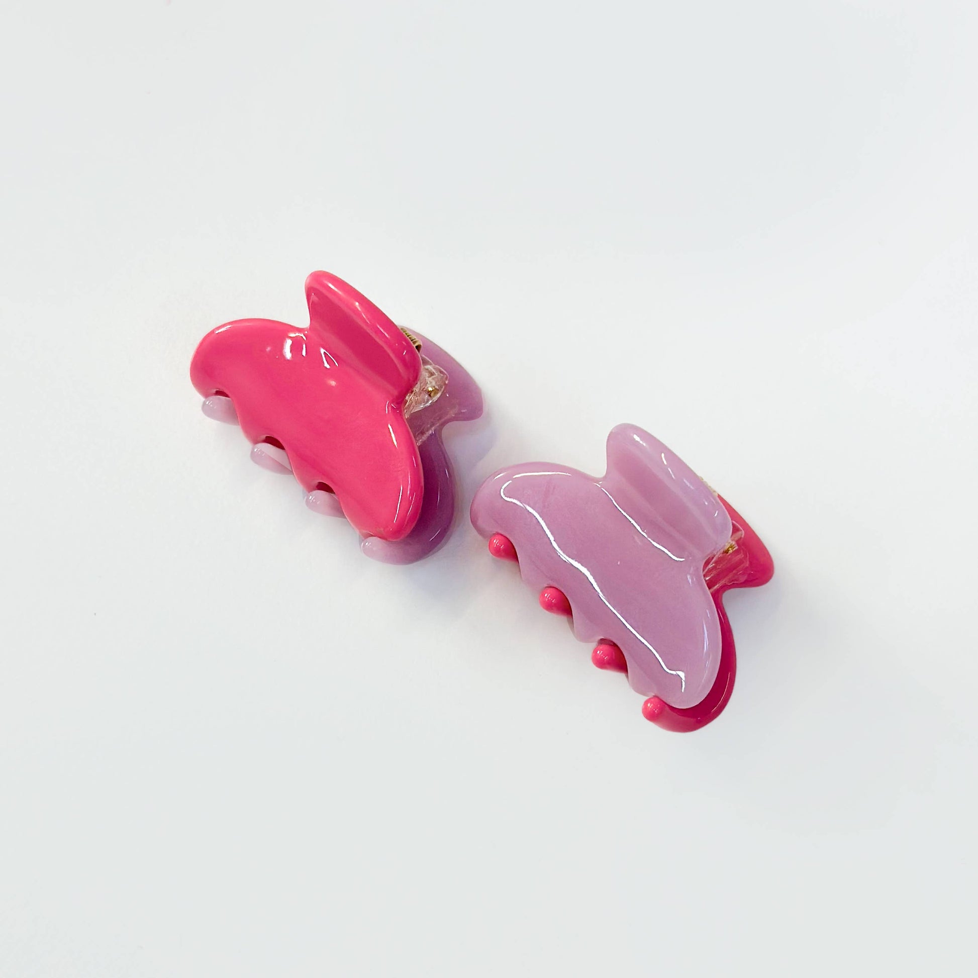 Set of two magenta and lilac translucent jelly hair claw clips.