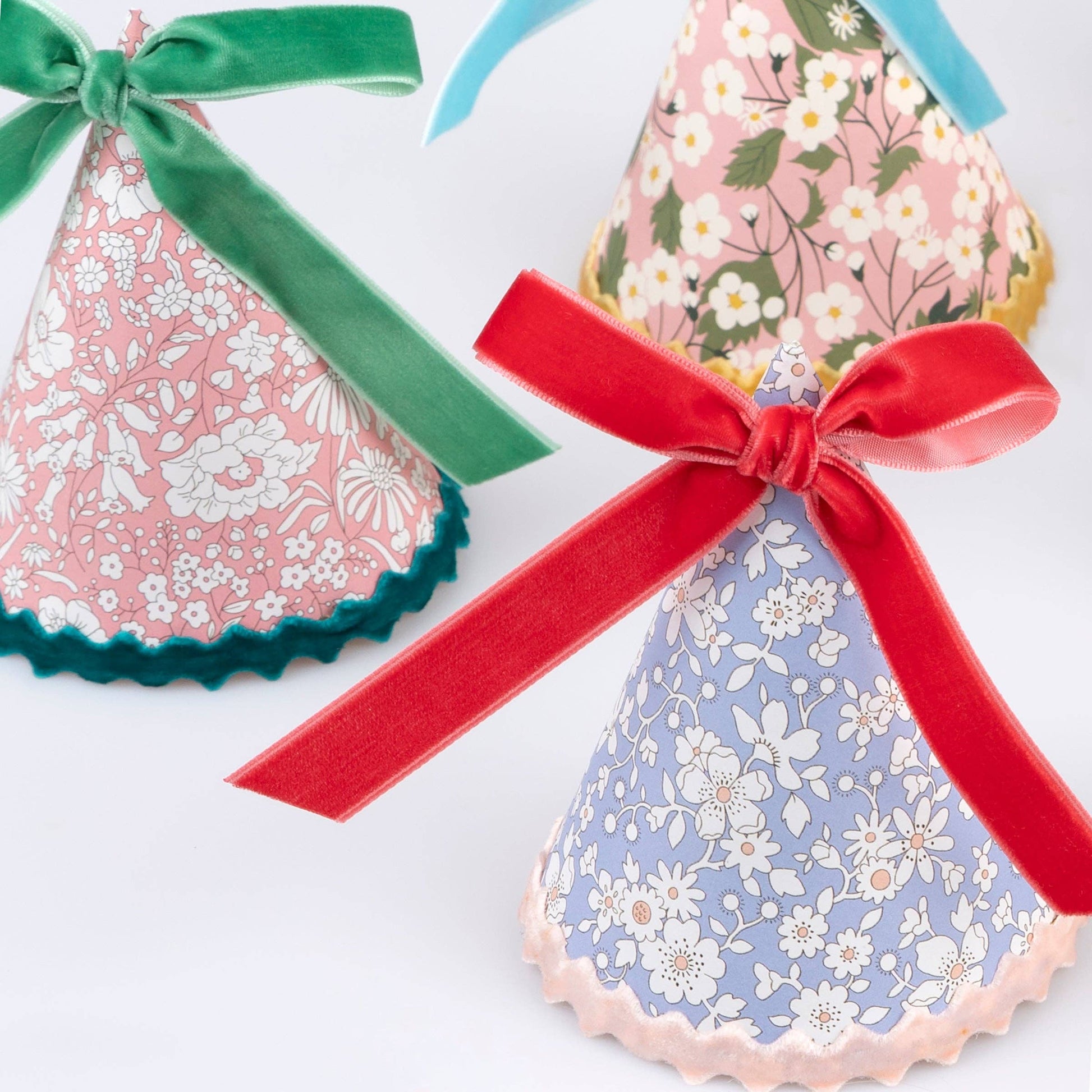 Liberty floral party hat with a velvet bow and gold round elastic