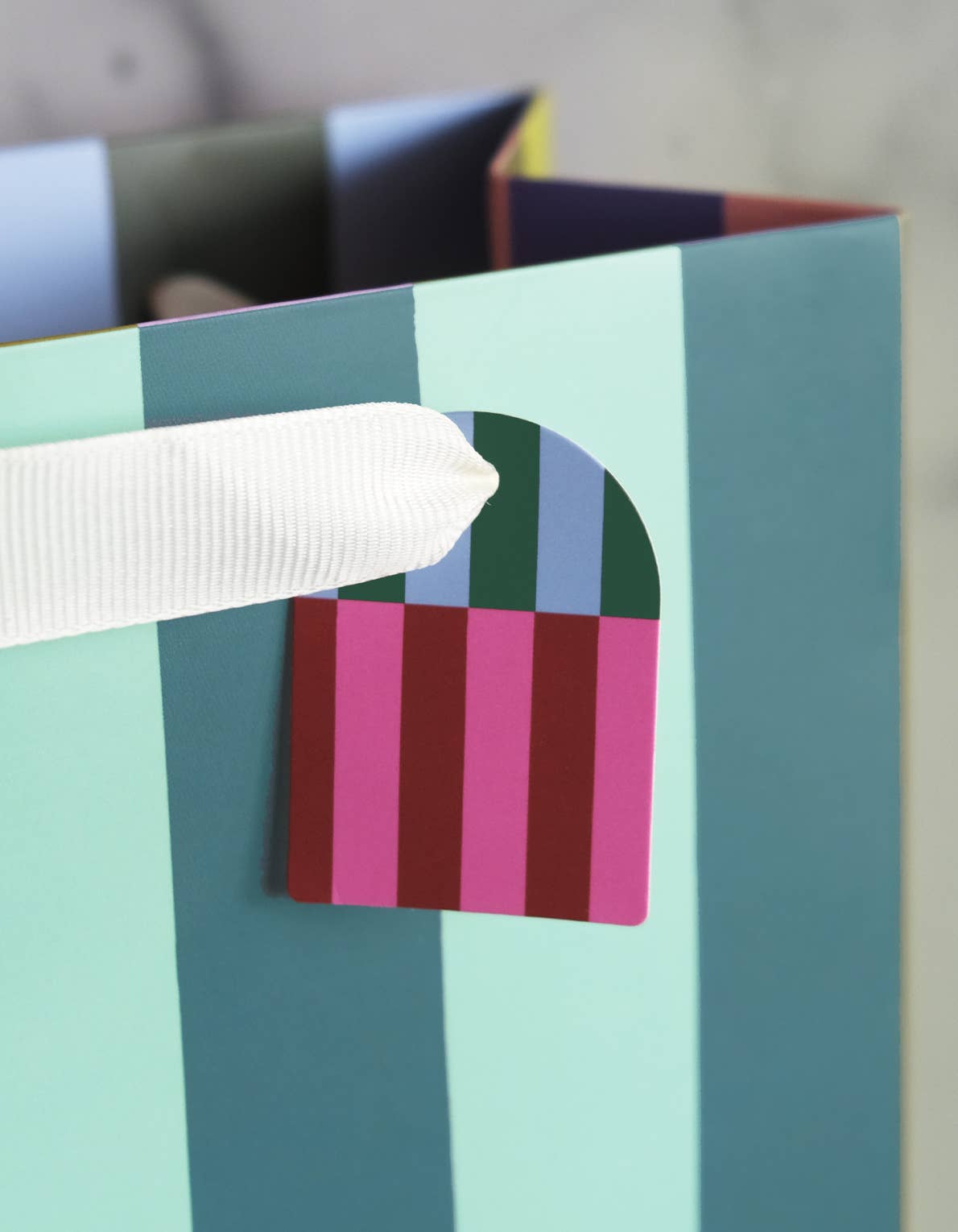 Colorful geometric-patterned tag with a white ribbon