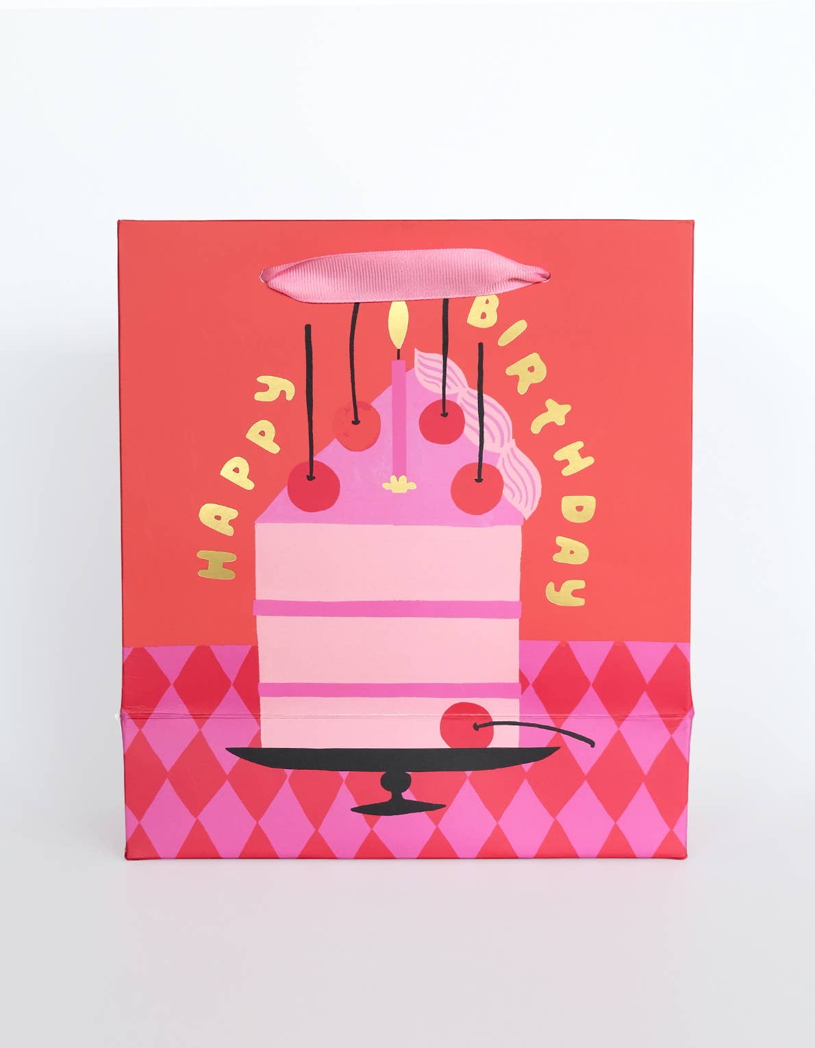 Gift box with a pink birthday cake design on a red background