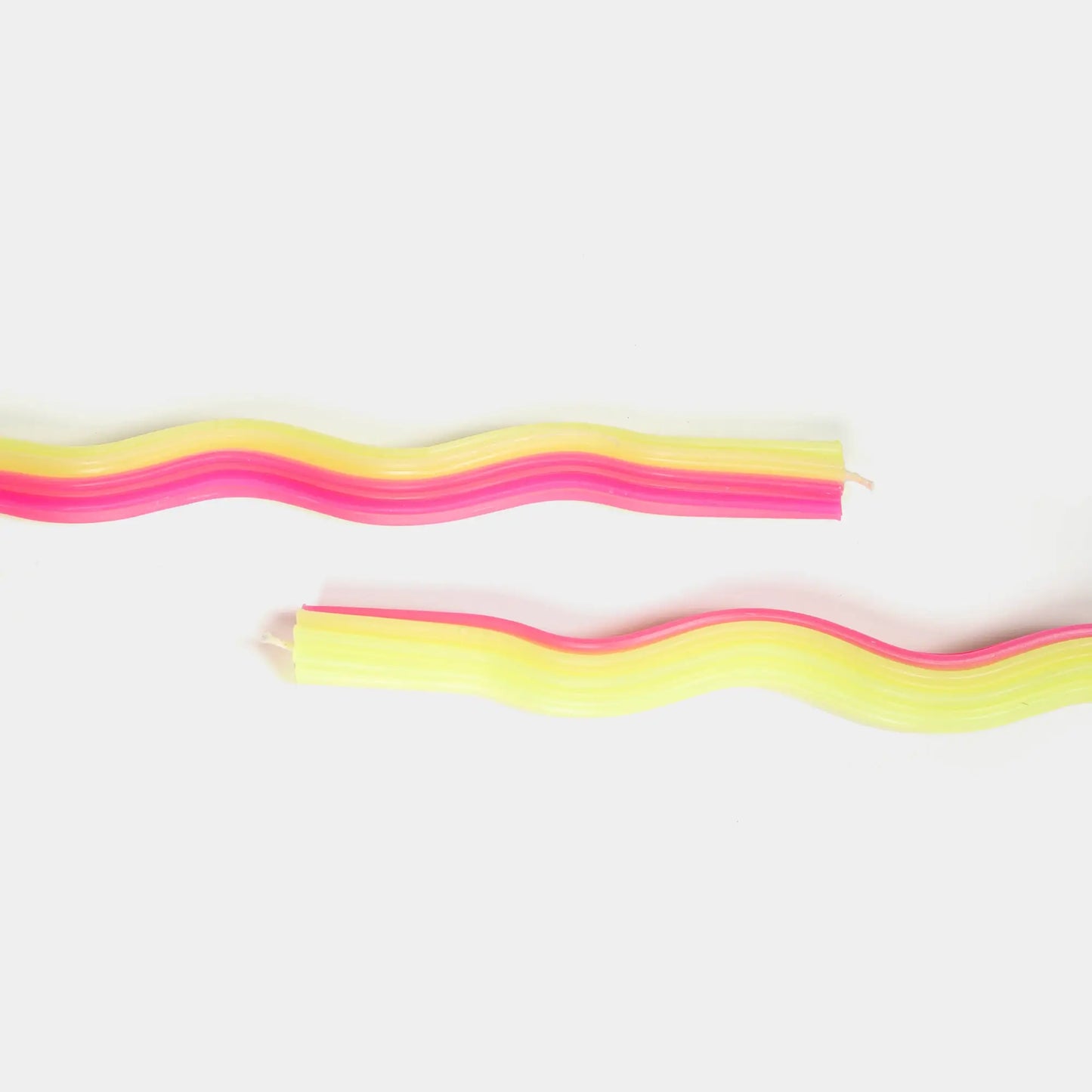 Wiggle taper candles in yellow and pink, 11 inches tall