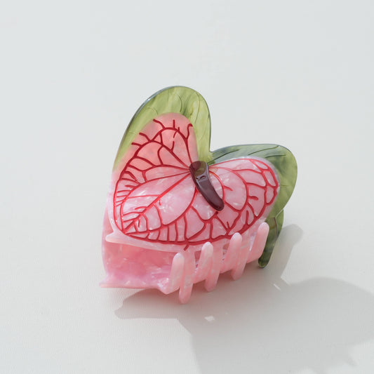 Pink and green anthurium-flower claw hair clip on a white background