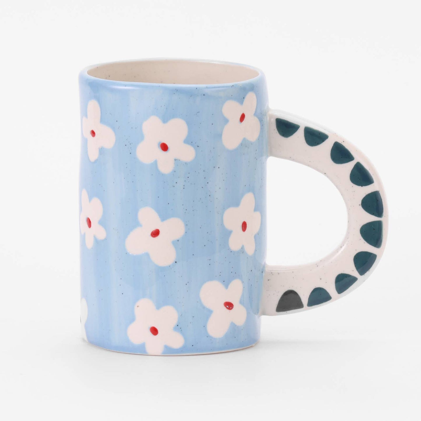 Hand-painted light-blue stoneware mug scattered with small white daisies, with a navy dotted handle.