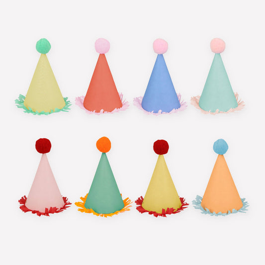 Set of eight mini party hats with crepe fringing and pompoms in bright colors