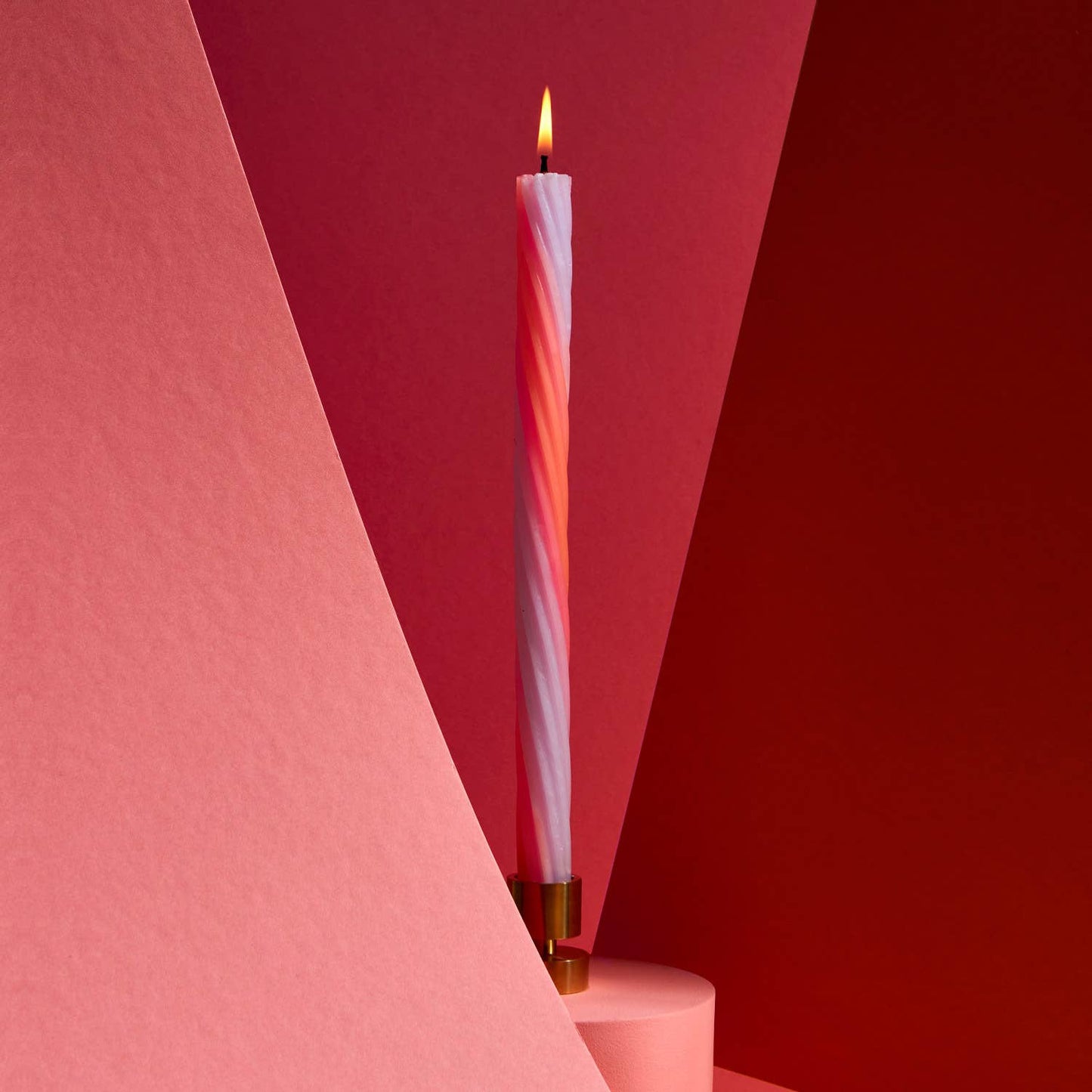Orange rope taper candles showing the woven spiral texture