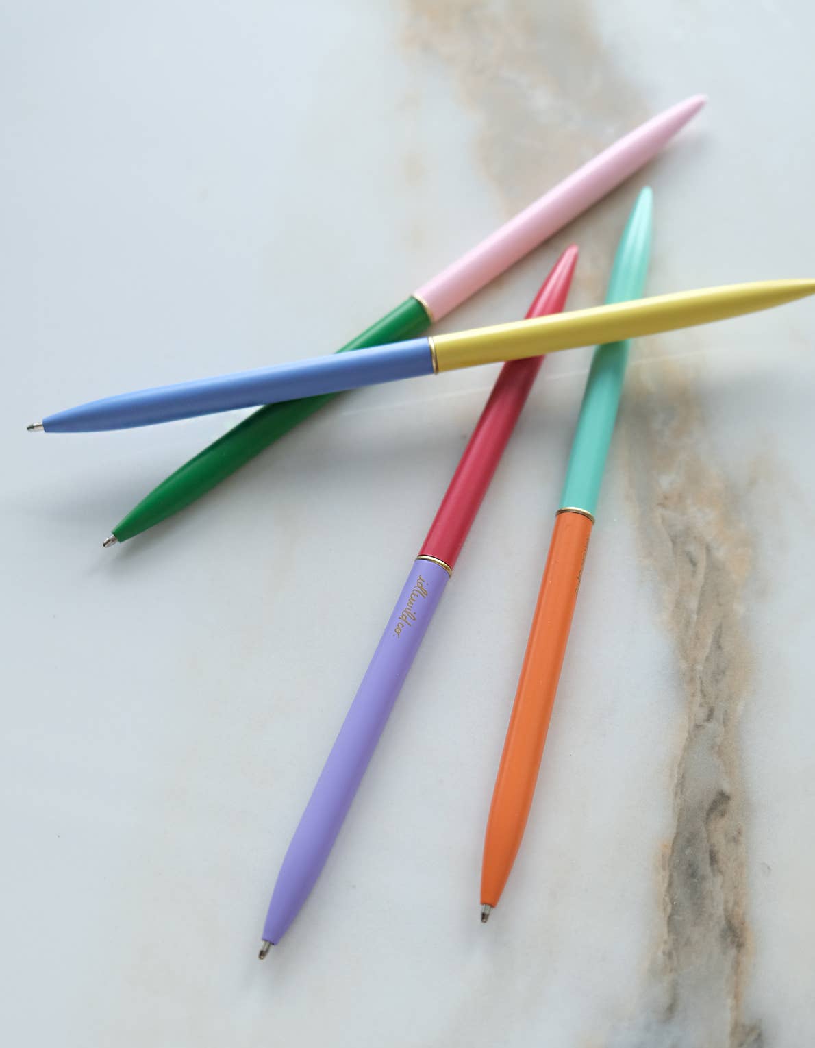 Colorful pens on a marble surface