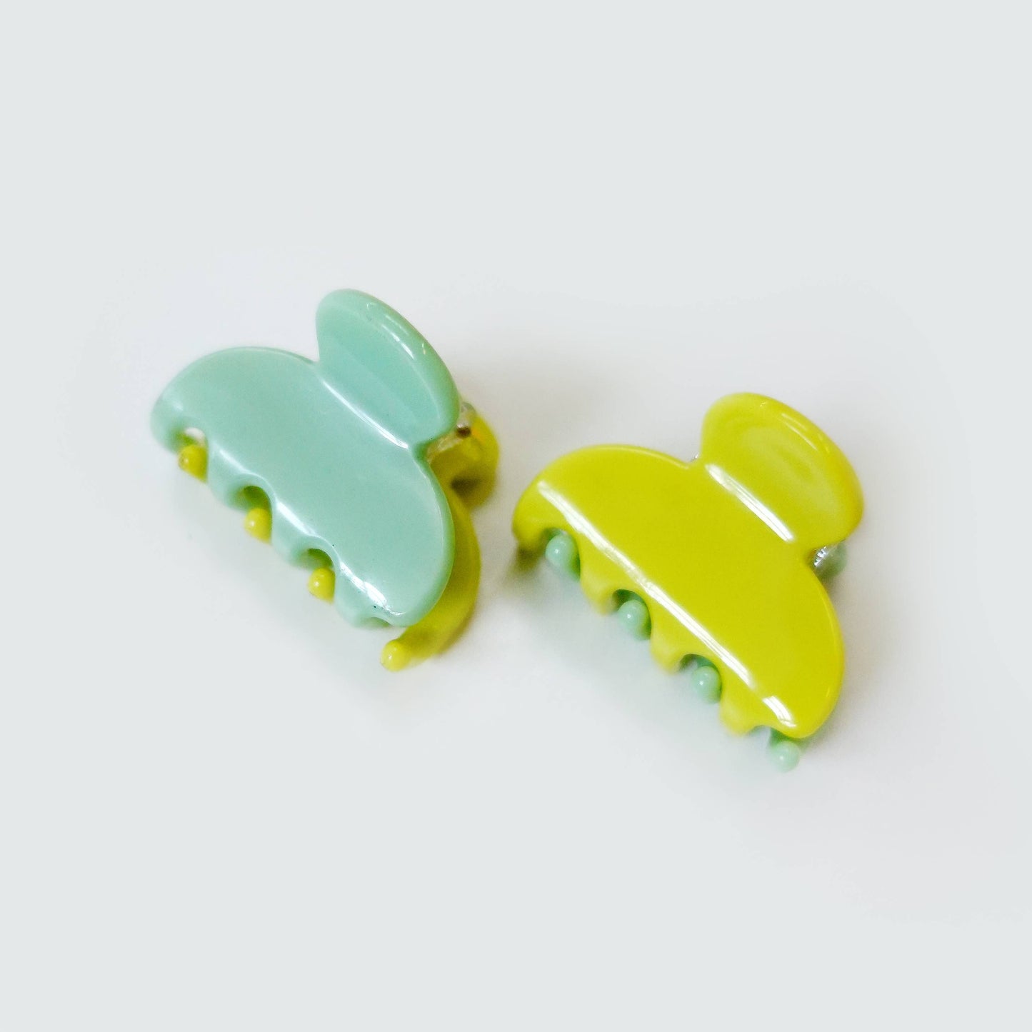 Set of two mini teal and green jelly hair claw clips.