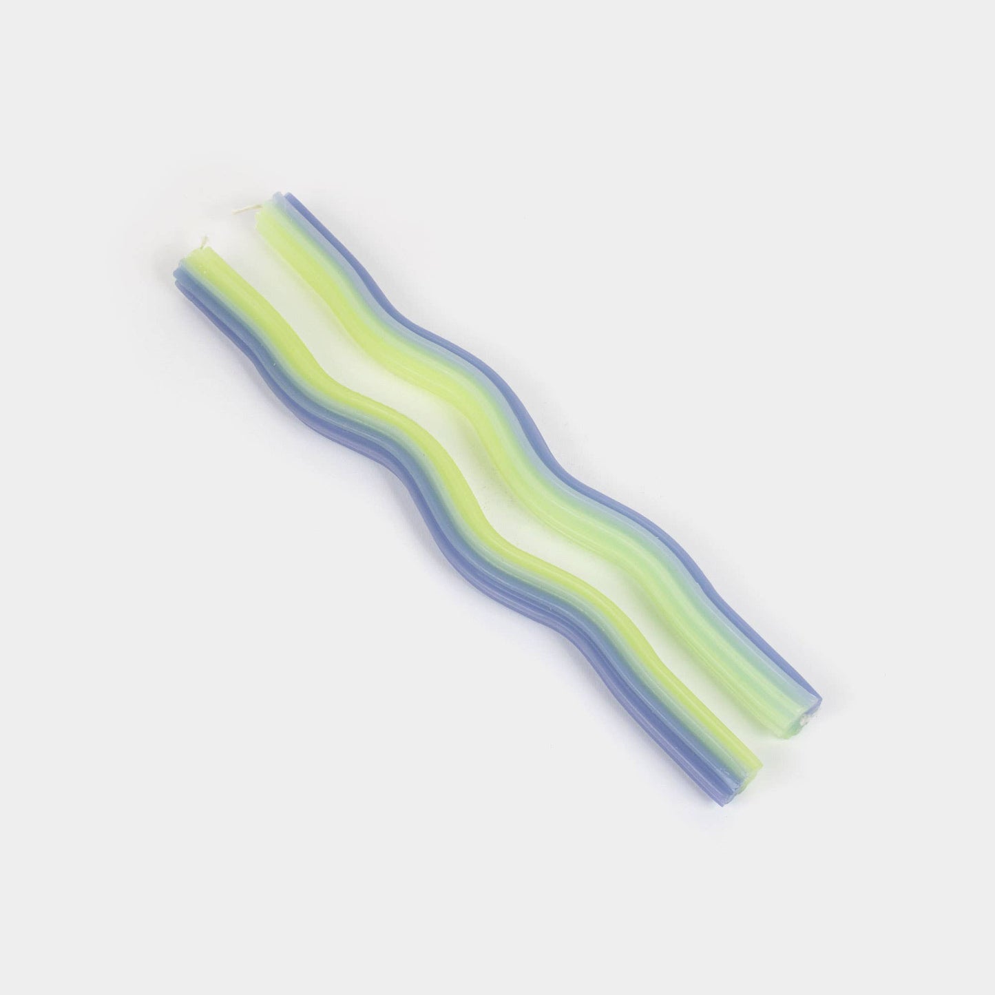 Lavender and green wiggle taper candles showing their undulating wave shape