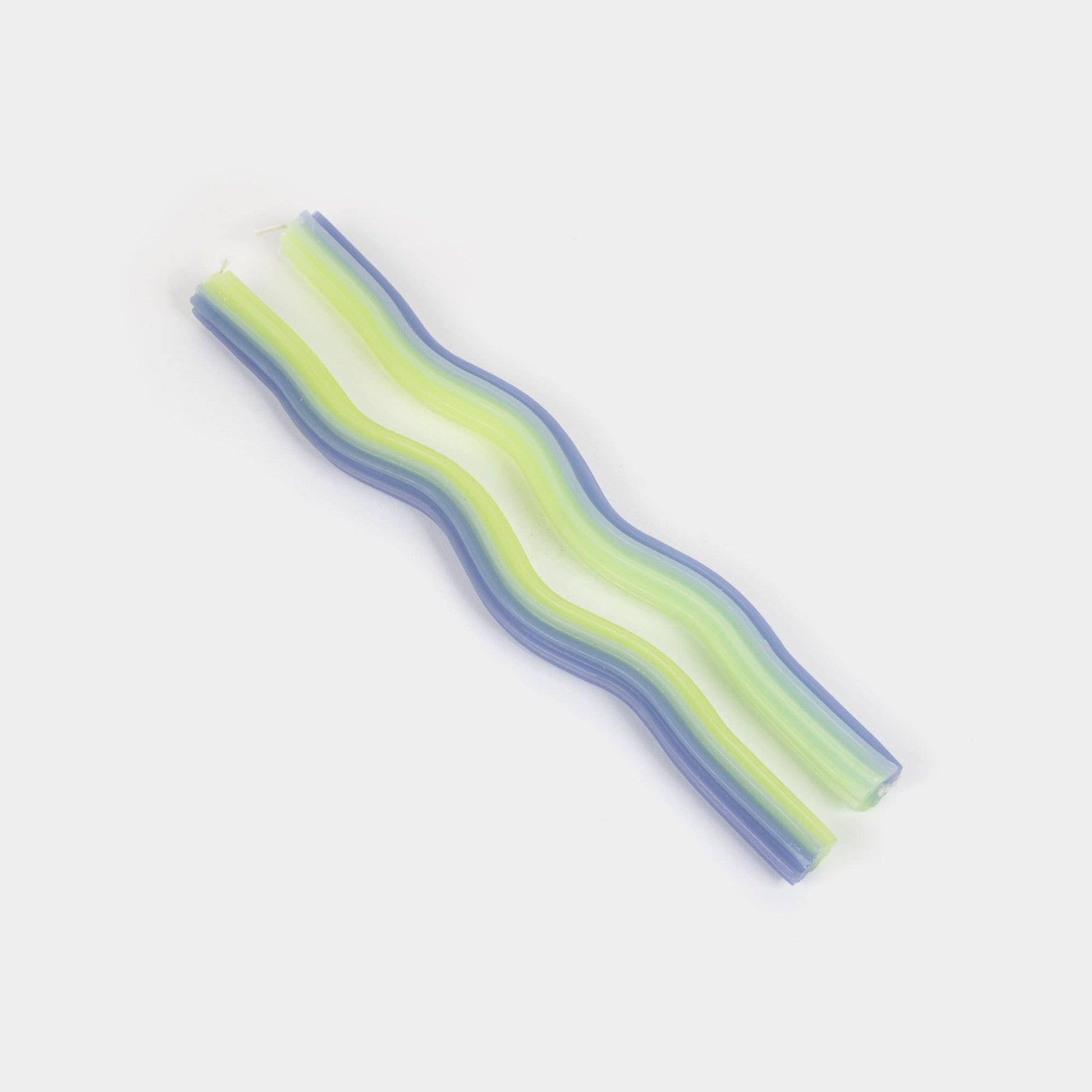 Lavender and green wiggle taper candles showing their undulating wave shape