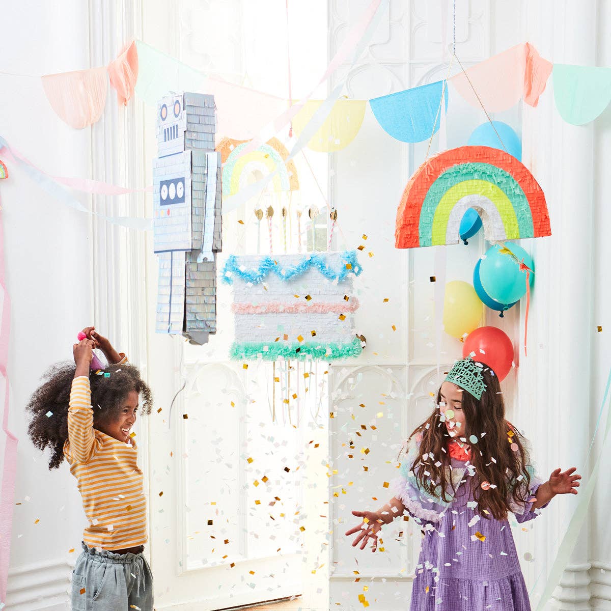 Close view of the cake piñata's striped paper-straw candles topped with gold foil flames