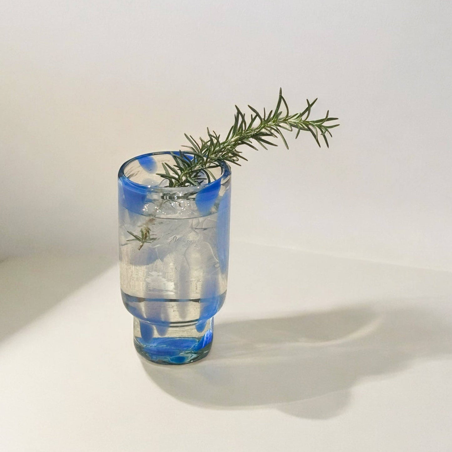 The Frida tall glasses in blue and clear, shown from another angle.