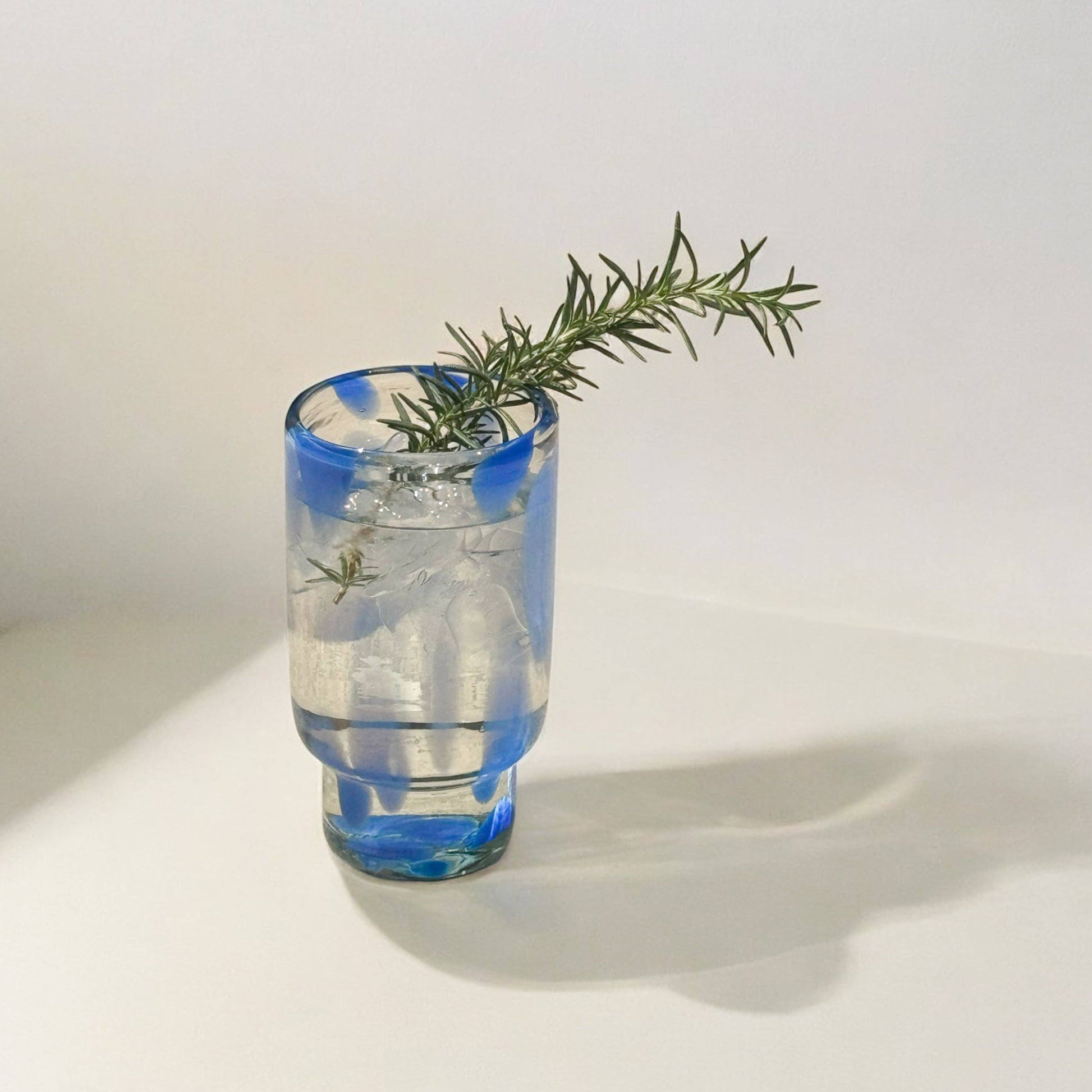 The Frida tall glasses in blue and clear, shown from another angle.