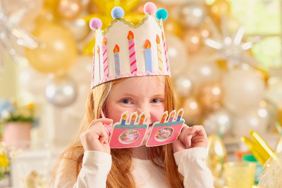 Multicolor pom poms along the top of the birthday crown.