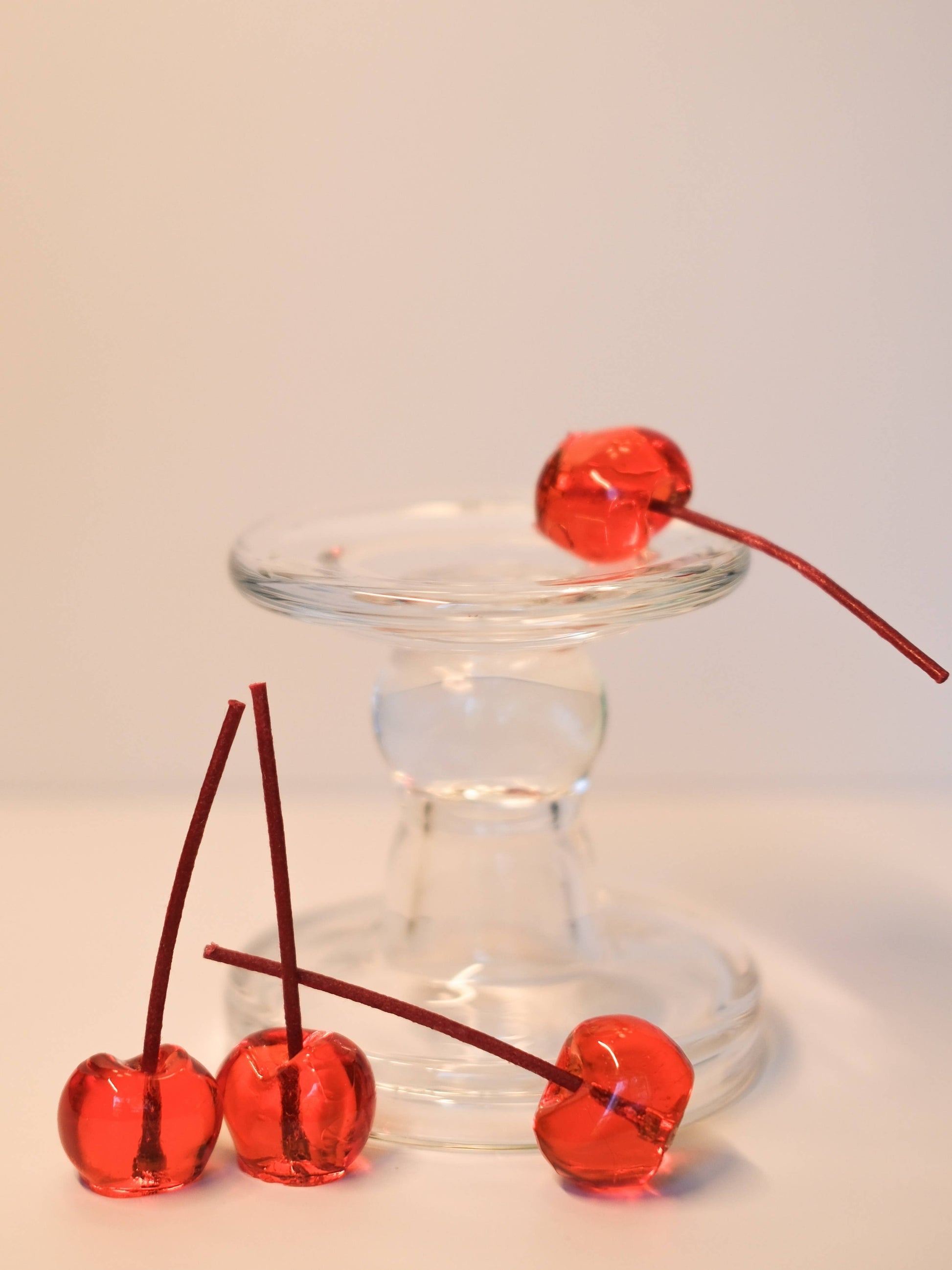 The glossy red cherry candles arranged together as a set of four.