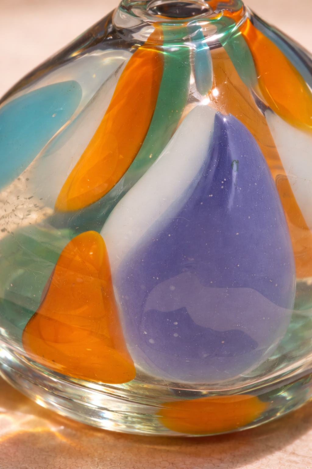 Detail of the color strokes on the clear glass bud vase.