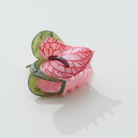 Pink and green anthurium-flower claw clip, alternate angle, on a white background