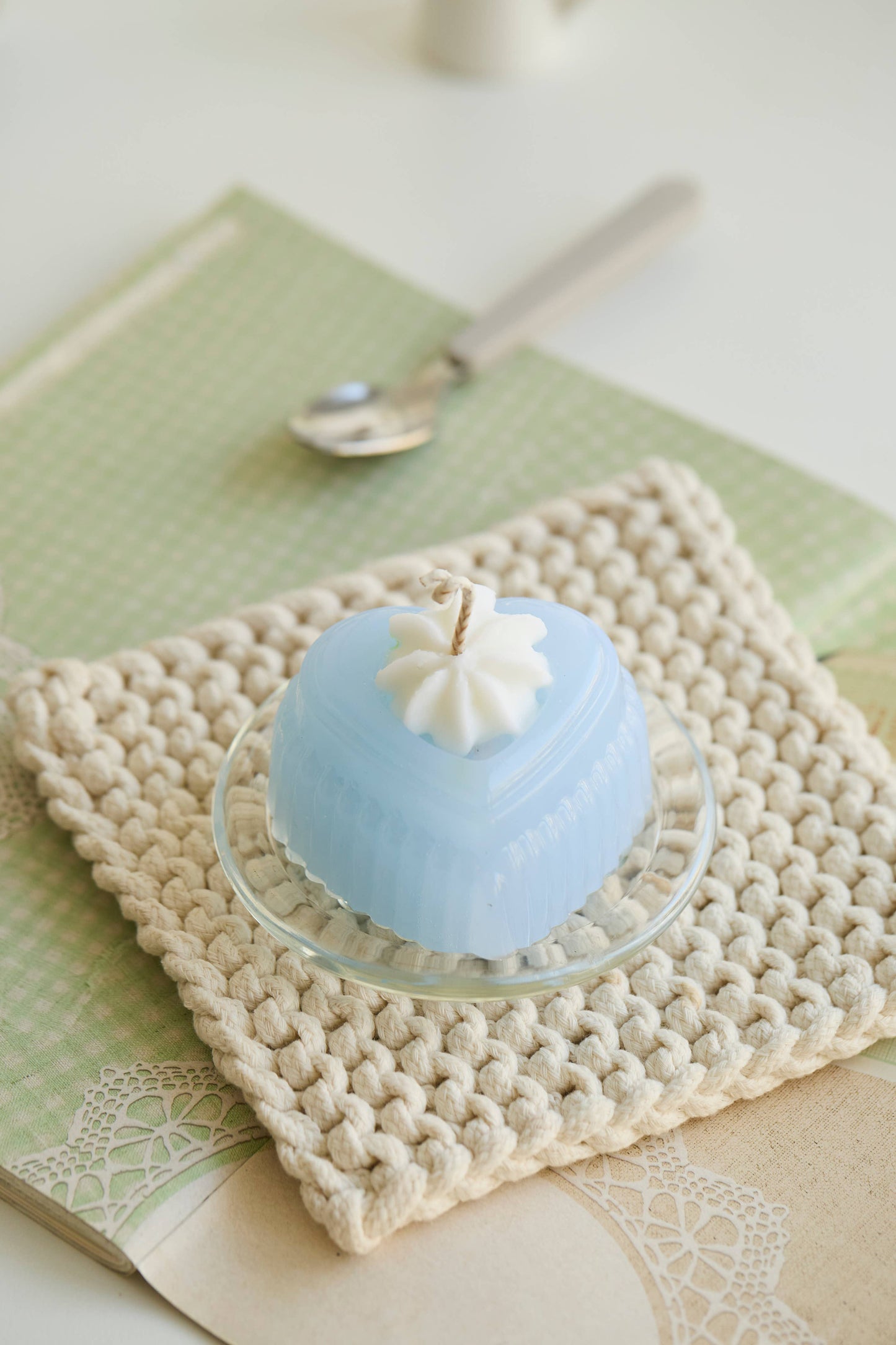 The Adoration candle, scented in the citrus-and-wood Aurora Mist blend.