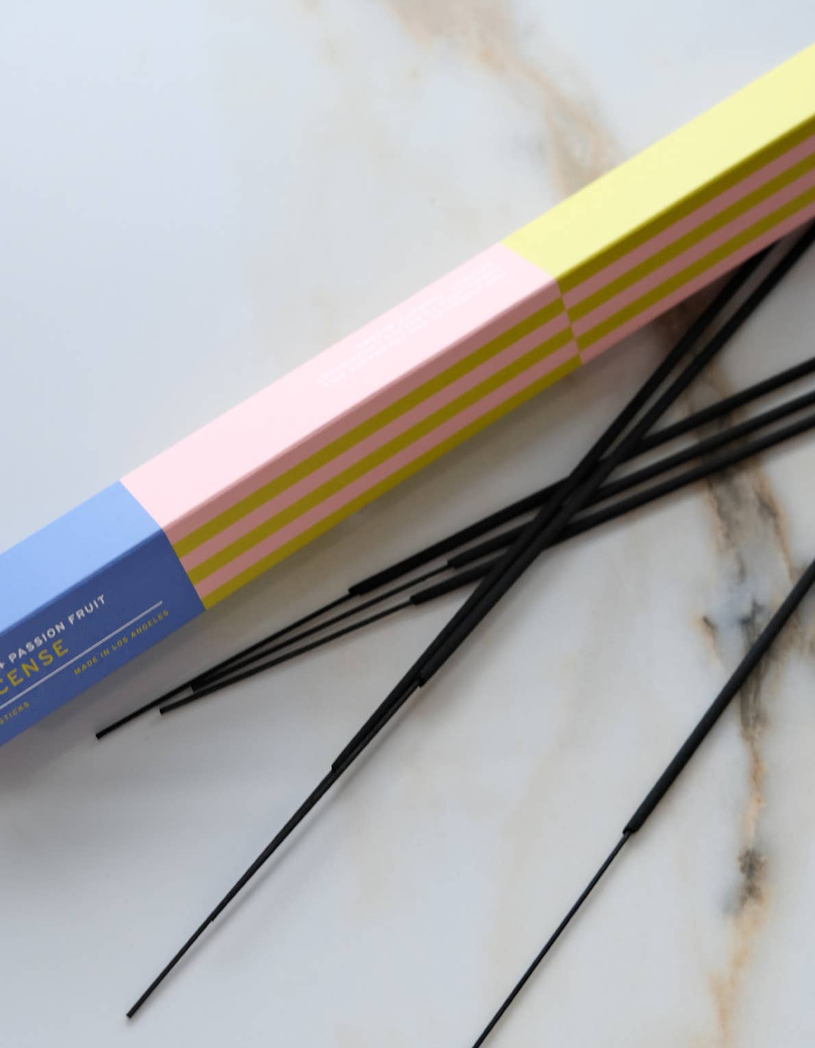Botanica Yuzu + Passion Fruit incense sticks beside their box