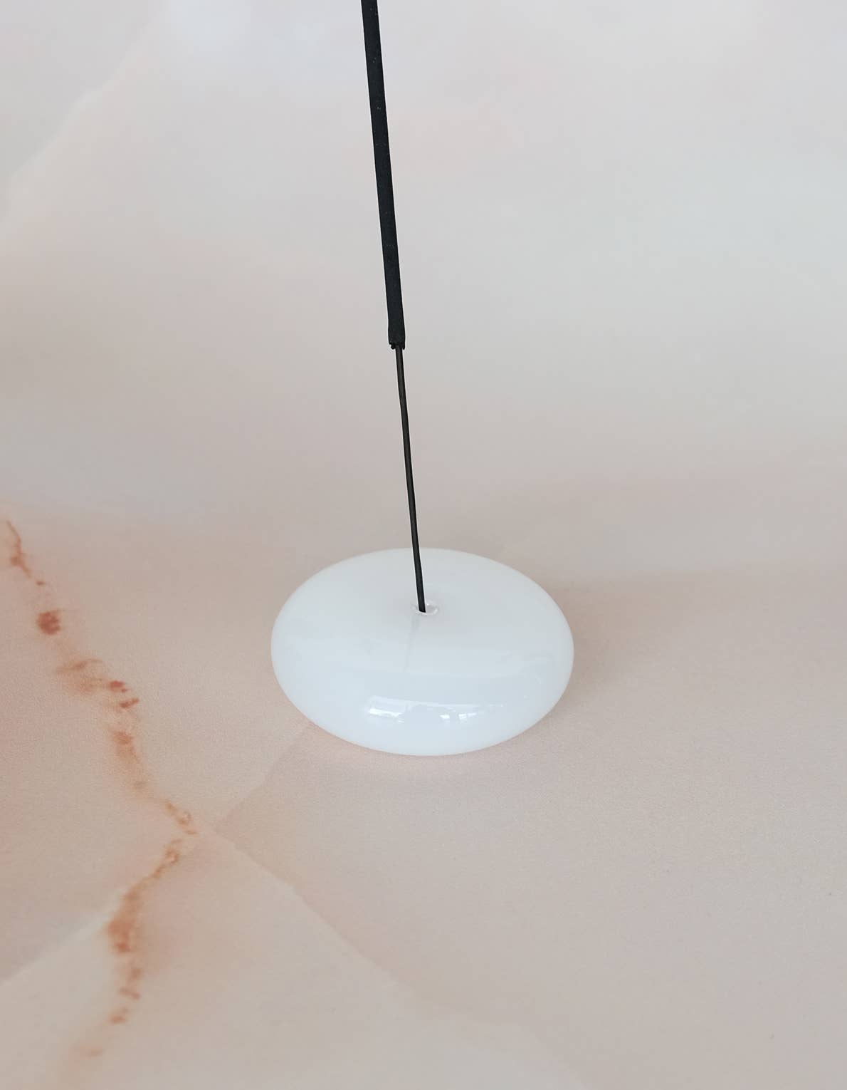 Bubble glass incense holder styled on a surface