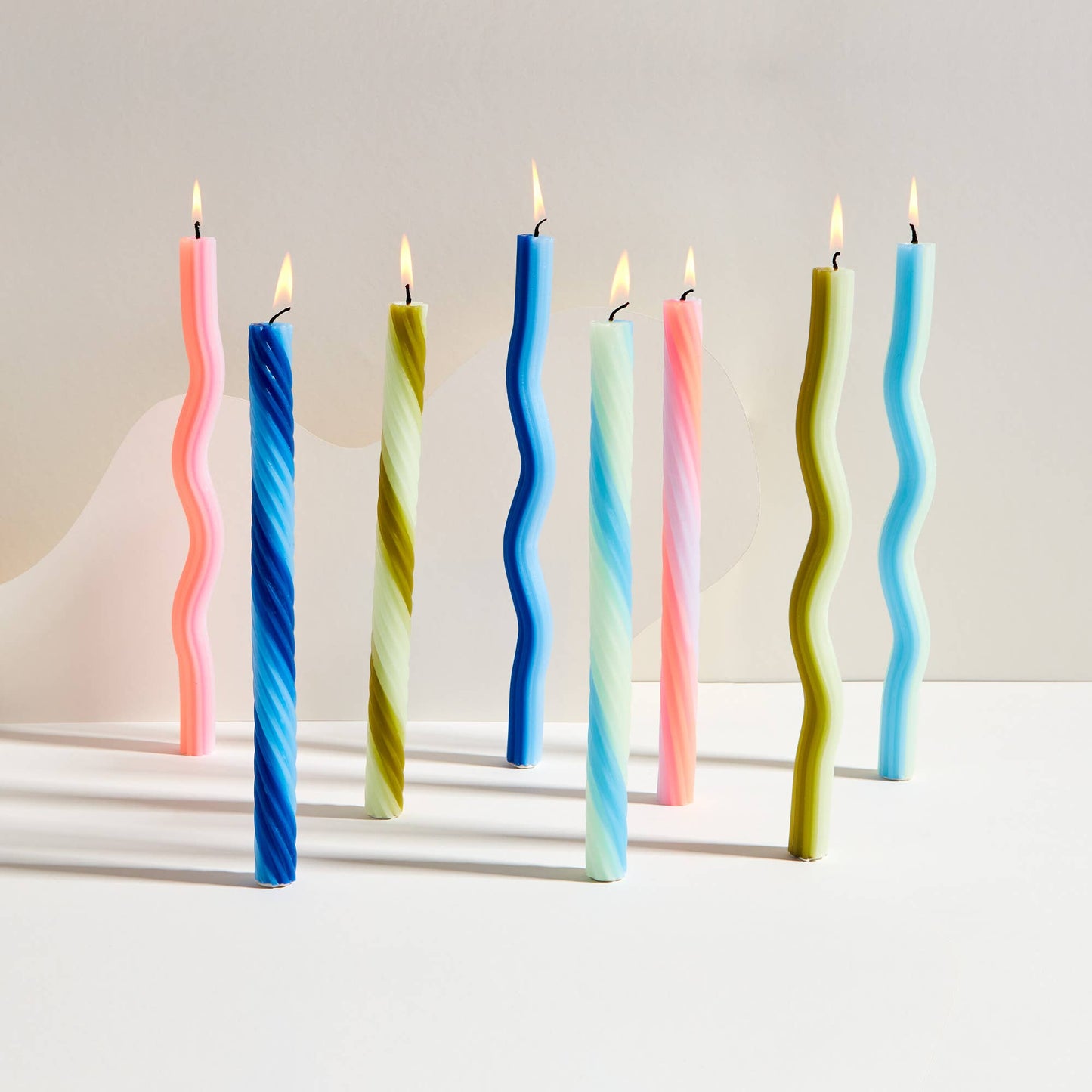 Detail of the multi-colored spiral wax of an orange rope taper candle