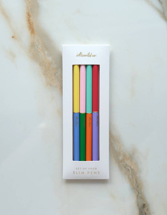 Set of four slim ballpoint pens in coordinating rainbow colors with packaging