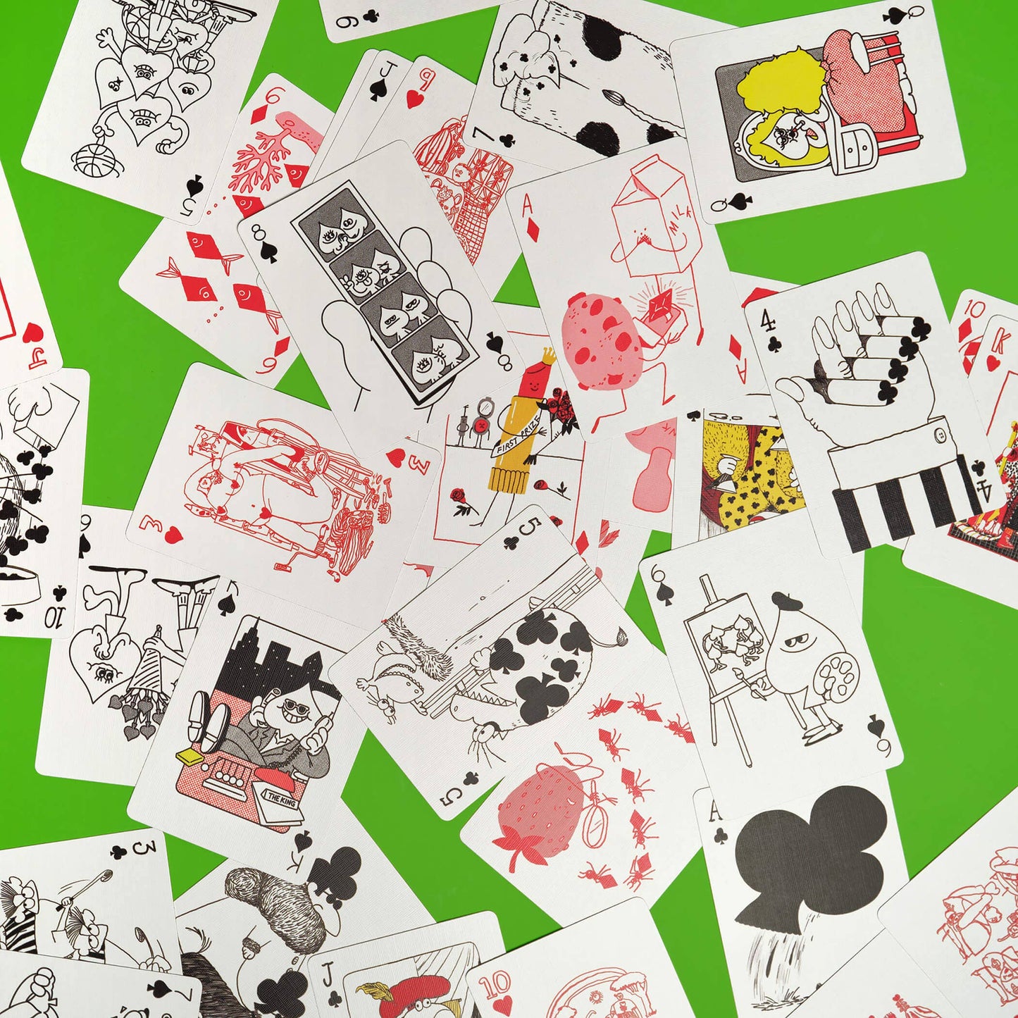 Collection of playing cards with various illustrations on a green background