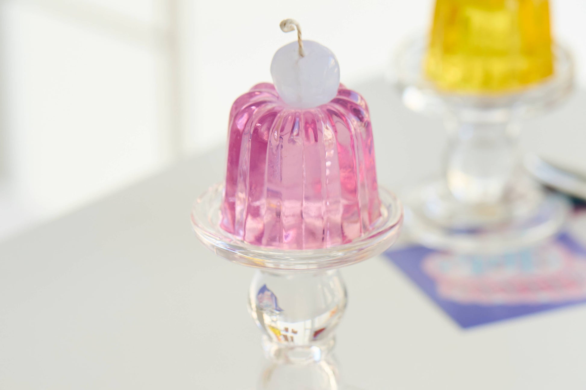 The Bashful Affection candle showing its fluted violet Canele form.