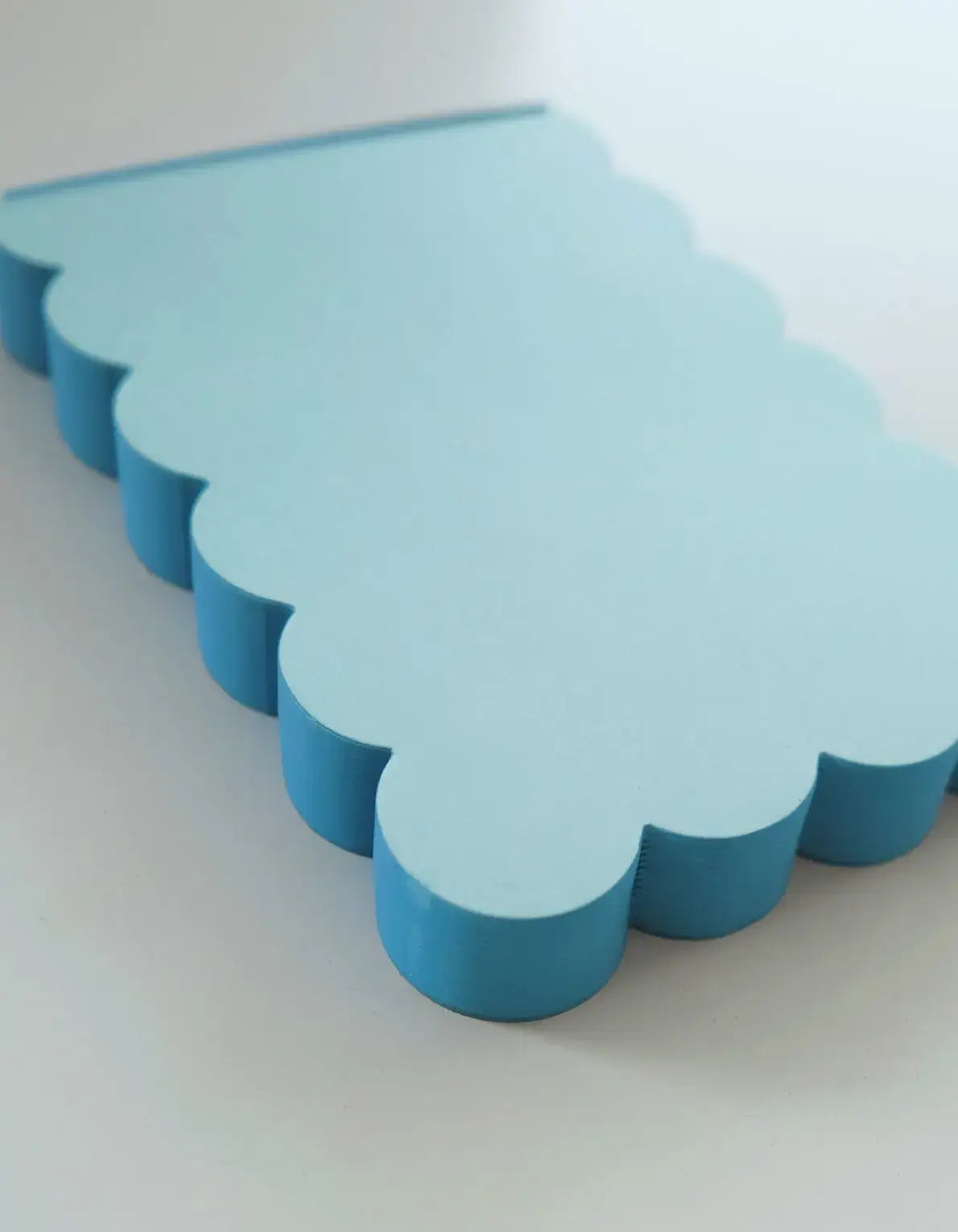 Blue scalloped-edged object on a white background