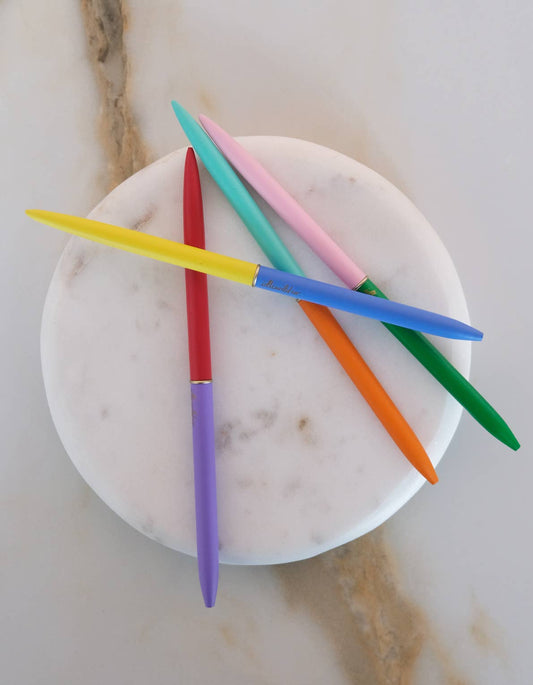 Colorful knitting needles on a marble surface