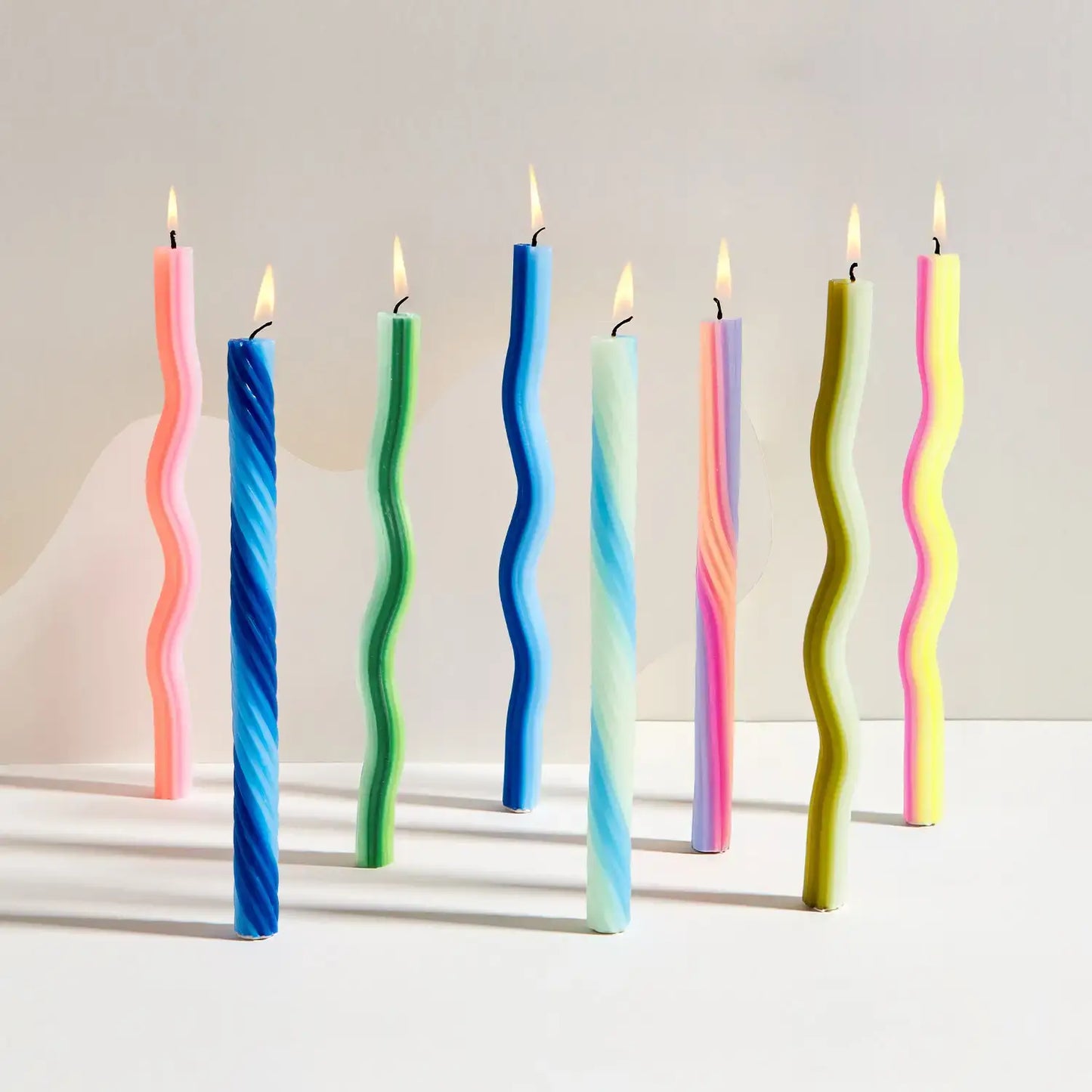 Pair of yellow and pink wiggle candles for a standard candleholder
