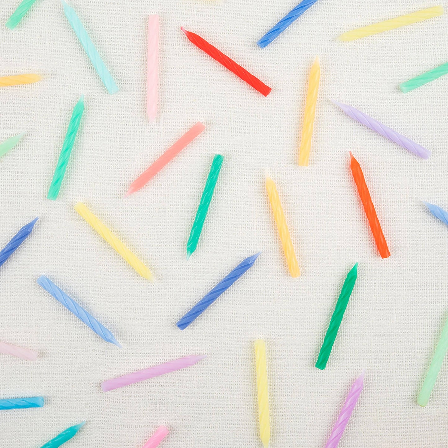 Twisted mini candles fanned out across the full color range