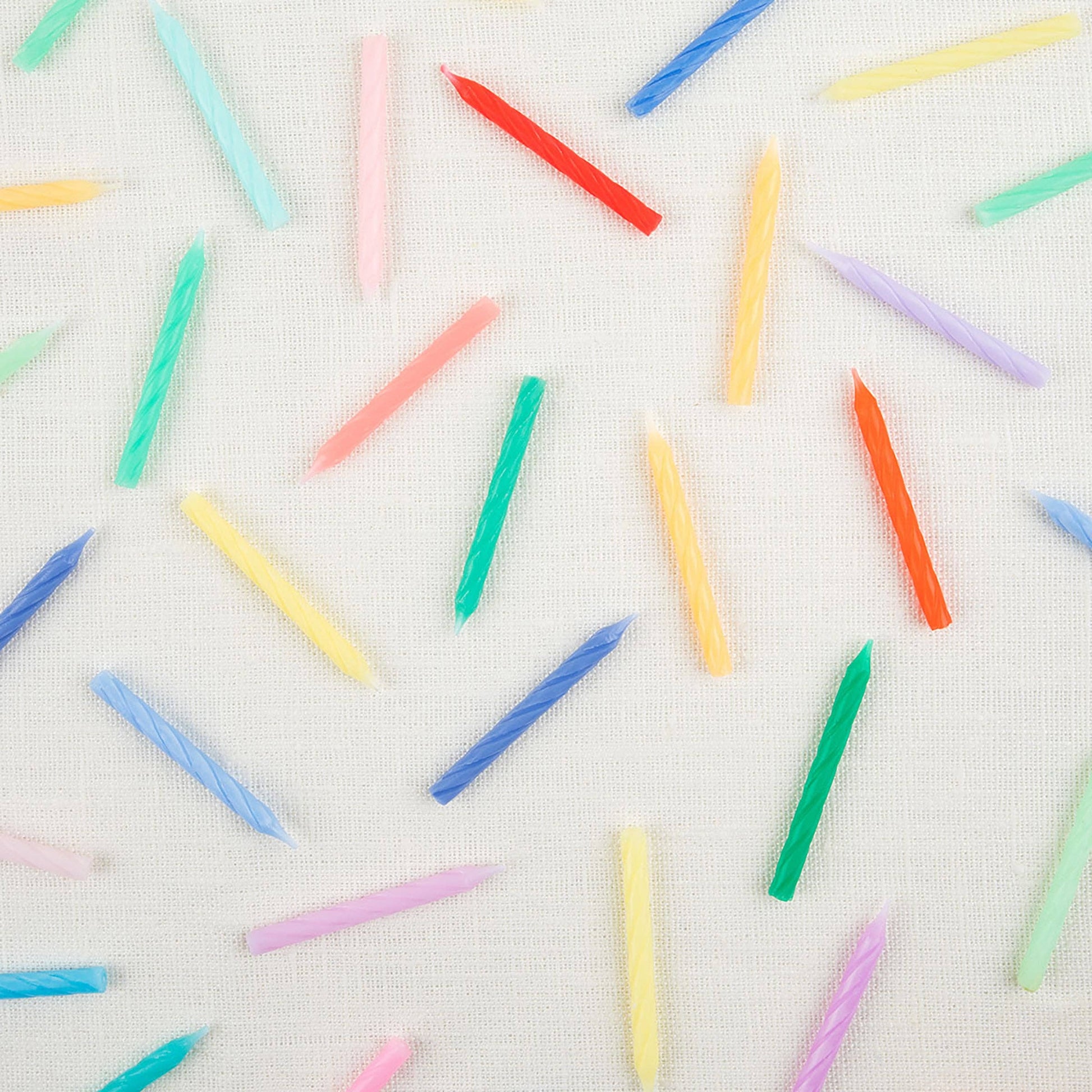 Twisted mini candles fanned out across the full color range