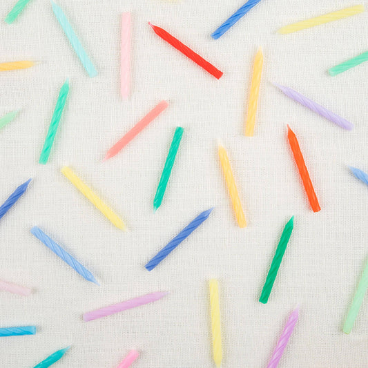Twisted mini candles fanned out across the full color range