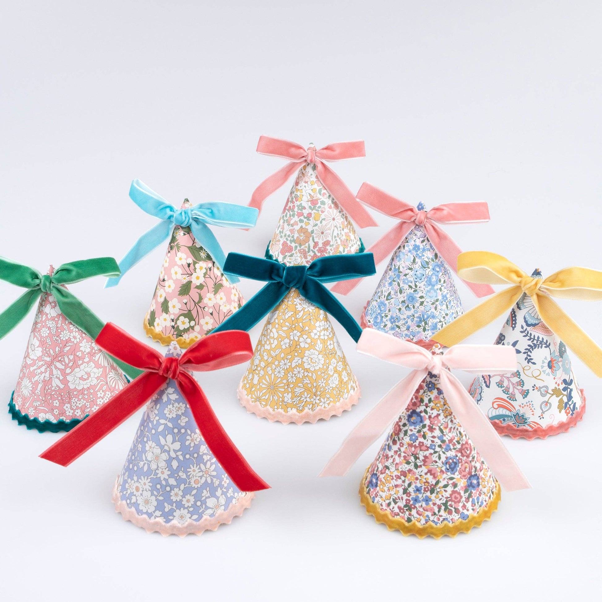 Set of Liberty floral-print paper party hats finished with velvet bows