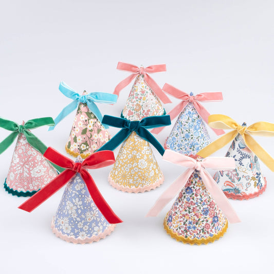 Set of Liberty floral-print paper party hats finished with velvet bows