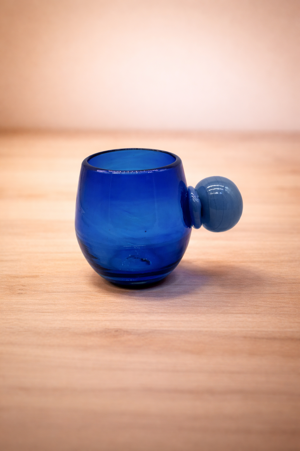 Close view of the handmade blue recycled glass of a Salinas glass.