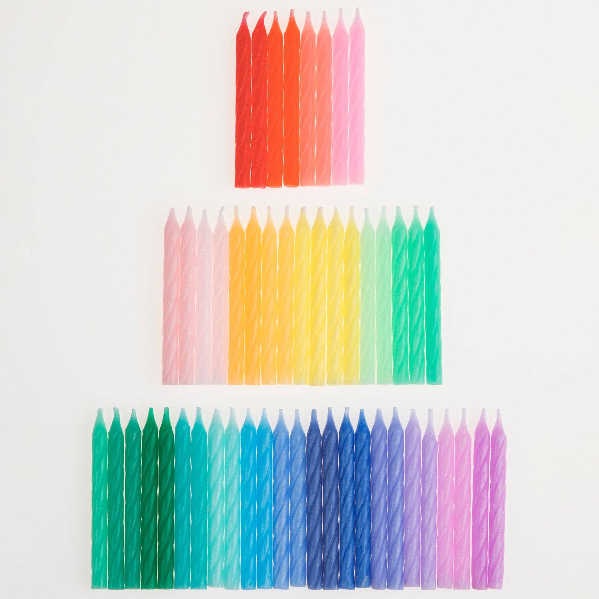 Rainbow twisted birthday candles gathered in a bunch
