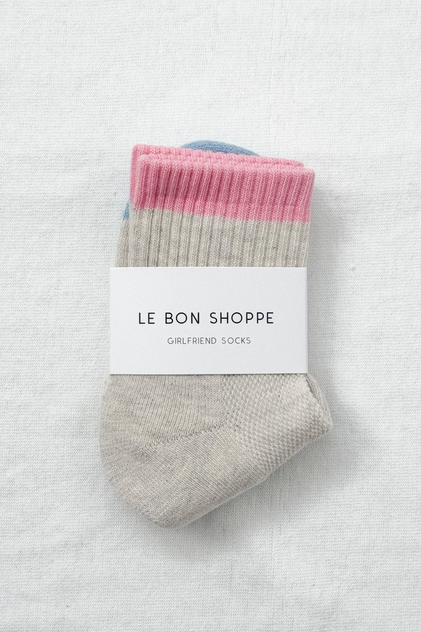 Pair of socks with pink and gray pattern on a white background, branded 'Le Bon Shoppe'.